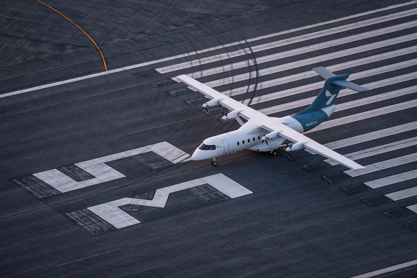 Brief image: X1 taxiing over the runway numbers